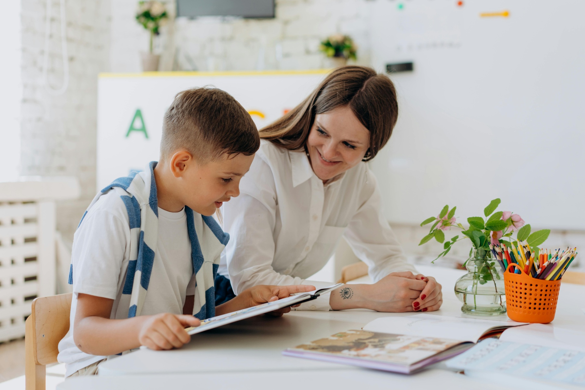 Tutor helping a student read and learn